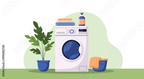 Modern front loading washing machine in a clean laundry room setting with folded towels, detergent, and a decorative indoor plant.