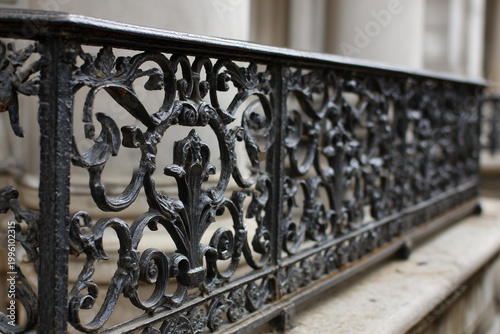 Wrought iron railing design on modern staircase showcasing detailed craftsmanship and artistic features in a residential setting