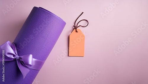 purple yoga mat with blank tag and bow on pastel background