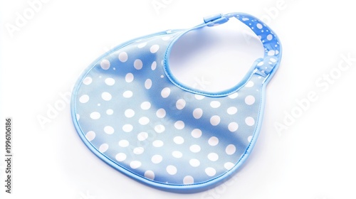 A blue baby bib with white polka dots on a plain white background