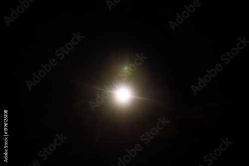 Easy to add lens flare effects for overlay designs or screen blending mode to make high-quality images. Abstract sun burst, digital flare, iridescent glare over black background.