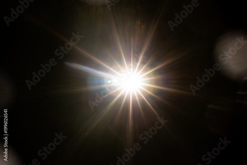 Easy to add lens flare effects for overlay designs or screen blending mode to make high-quality images. Abstract sun burst, digital flare, iridescent glare over black background.