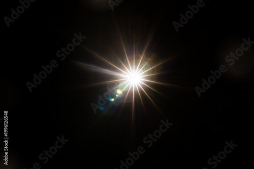 Easy to add lens flare effects for overlay designs or screen blending mode to make high-quality images. Abstract sun burst, digital flare, iridescent glare over black background.