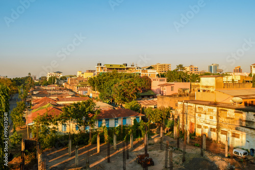 Misty sunrise over the residential rooftops and rolling hills of Moshi Town, Tanzania