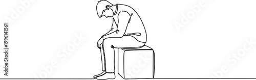 a man sitting on a box with his head down in sadness