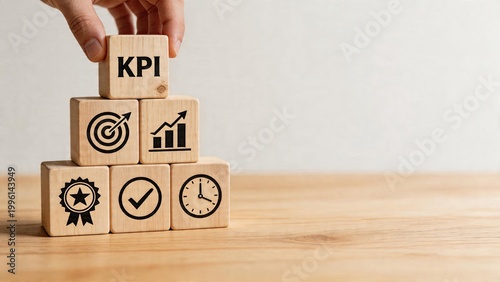 Business man hand placing wooden block with KPI text pyramid structure of success metrics including target arrow chart graph award star badge time management checkmark clock on