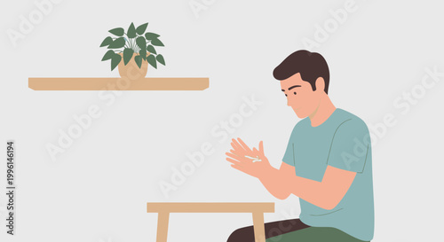 Man sitting at table, rubbing hands together, indoor, plant on shelf