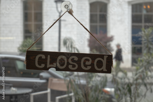Wooden Closed Sign Hanging on Storefront Window