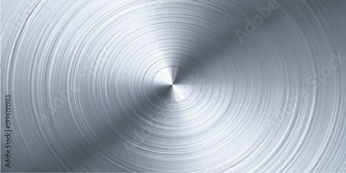 A shiny silver brushed metal plate with a circular stainless steel pattern creates an industrial grey texture reflection on a round aluminum surface