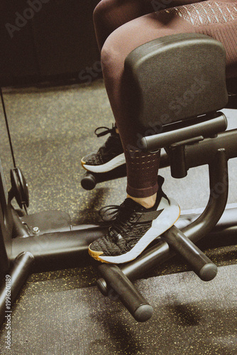 Close-up of a woman's legs exercising on gym equipment