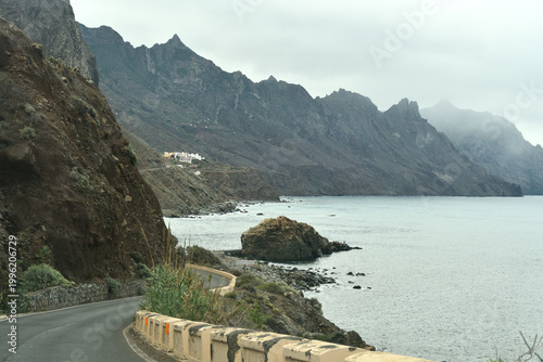 Fotografie Coastal road winding through rugged volcanic mountains and steep cliffs overlook