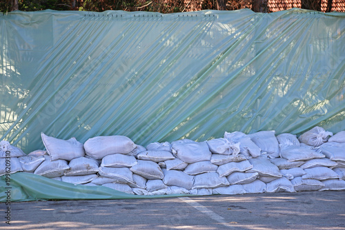 Wall of Sand Bags and Tarp Plastic for City River Water Spring Floods Protection