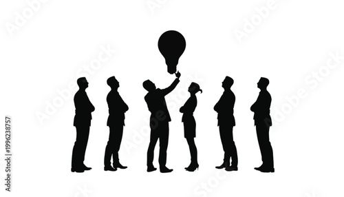 Businessman reaches for a glowing light bulb as his colleagues observe the creative process with focus.
