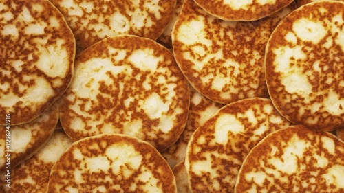 Motion background and texture of a mountain of pancakes. Top view. Fresh homemade pancakes.