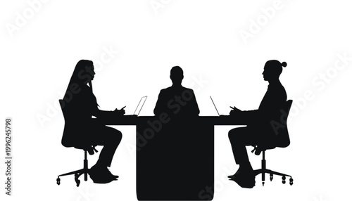 Professionals sit at a meeting table while collaborating on a new project in a quiet office space.