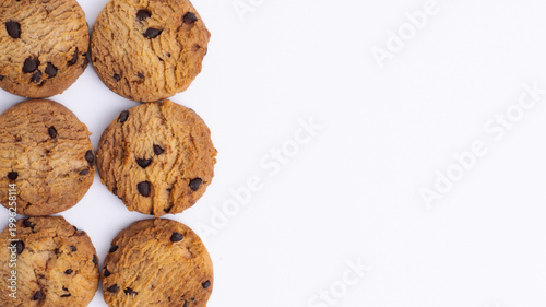 Flat lay chocolate chip cookies on left with large white copy space. Perfect for bakery advertising, sweet snack branding, and design templates.
