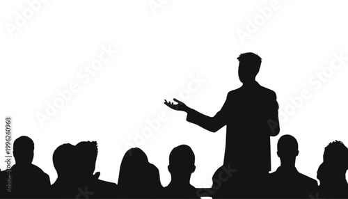 Speaker stands before an audience to deliver a formal presentation in a professional conference room.