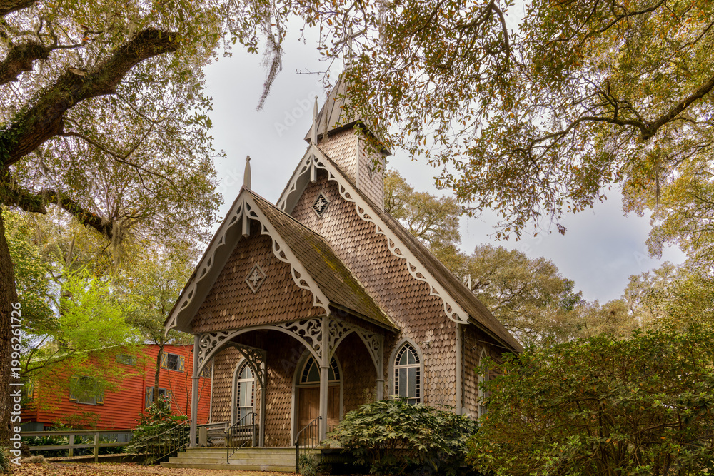 Fototapeta premium the historic St. James-Santee Episcopal Church framed by live oaks in early spring