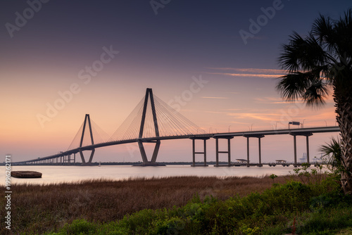 view of the Ravenel Bridge across the Cooper River in Charleston at sunset