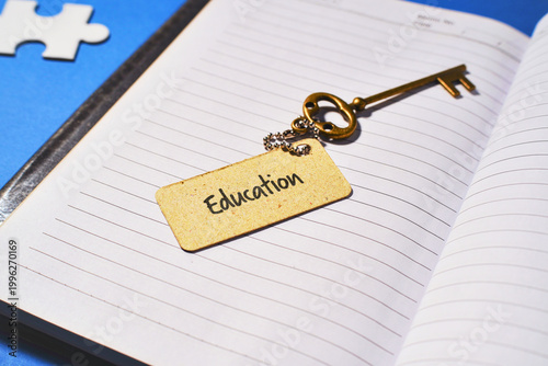 Education is the Key to Success Concept with Vintage Key and Open Notebook