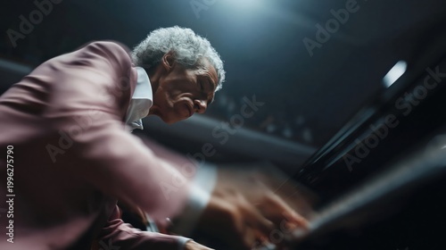 Elderly musician passionately plays piano with expressive motion blur on stage