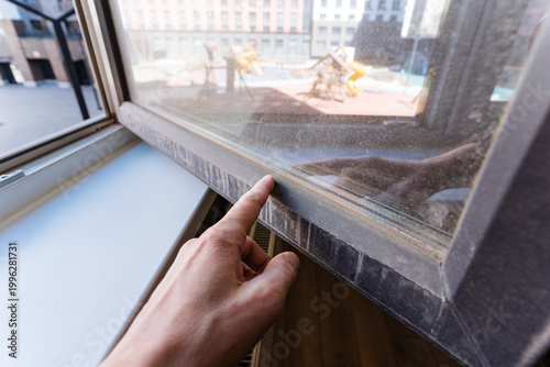 Fotografie Hand Inspecting Window Seal At Frame Edge, Fingertip Pressure And Careful Check