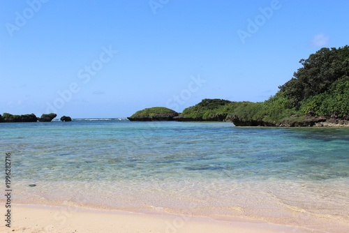 Hoshizuna-no-Hama (Star Sand Beach) on Iriomote Island, shallow, calm, turquoise color waters protected by rocky islets