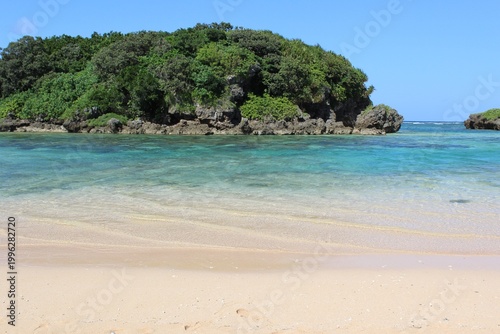 Star Sand Beach on Iriomote Island, shallow, calm, turquoise color waters protected by rocky islets