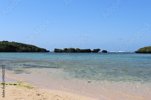 Star Sand Beach on Iriomote Island, shallow, calm, turquoise color waters protected by rocky islets