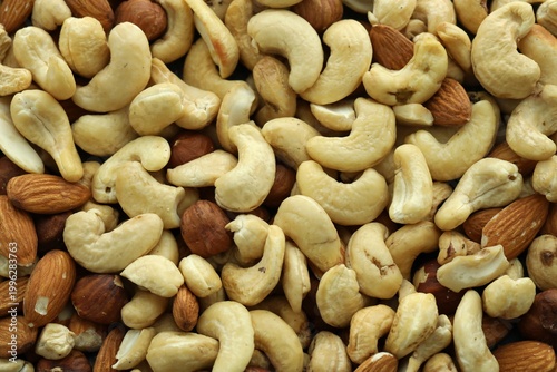 Konstfotografi Almond and cashew nuts in big pile on table close up
