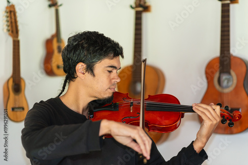 Man playing violin in home studio
