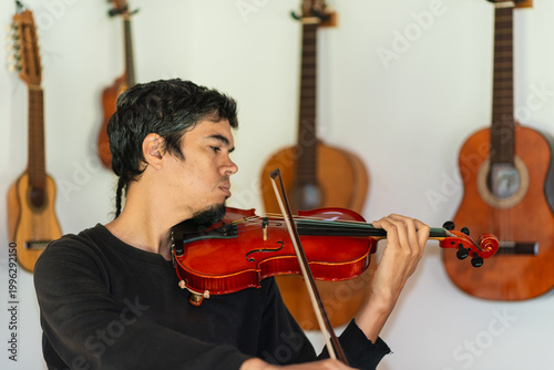 Man playing violin in home studio