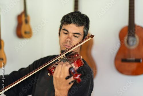 Man playing violin in home studio