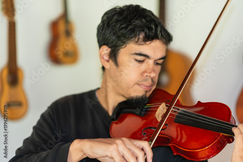 Man playing violin in home studio