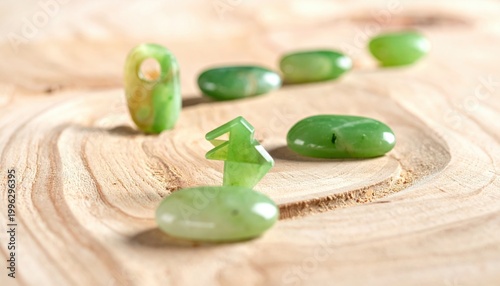 Polished jade stones carved into miniature directional markers resting on a smooth wooden surface, showcasing an elegant blend of natural beauty and intentional craftsmanship.