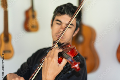 Man playing violin in home studio
