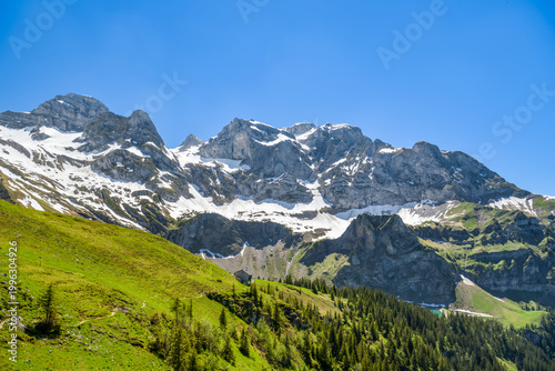 Snow capped Swiss Alps peaks above Bannalpsee