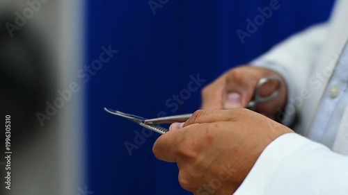 1080p 60fps horizontal video of a doctor assembling his scalpel for a medical operation
