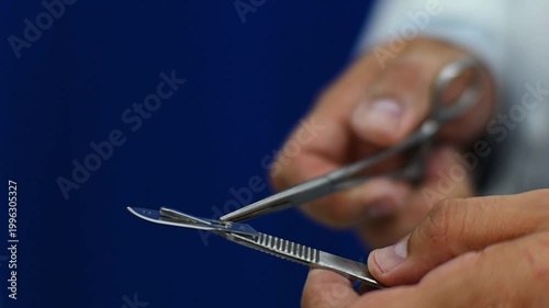 1080p 60fps horizontal video of a doctor assembling his scalpel for a medical operation
