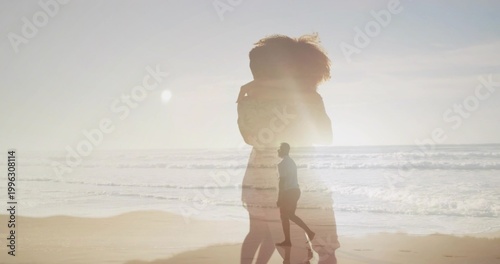 Foto Showing large translucent woman silhouette in profile at beach, with man walking