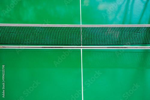 Obraz na płótnie Table tennis net close-up on green ping pong table with white lines