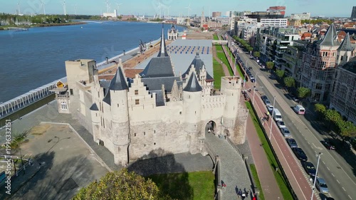 Aerial drone shot of Het Steen, a medieval fortress in the old city center of Antwerp, Belgium. View of the castle located on the banks of the Scheldt river.