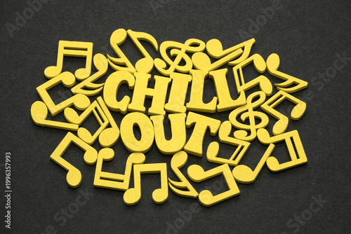 Obraz na płótnie Inscription chill out with yellow musical notes on black background