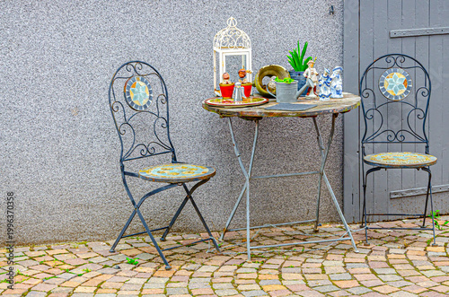 table and chairs, decorated with small lanterns and other objects 