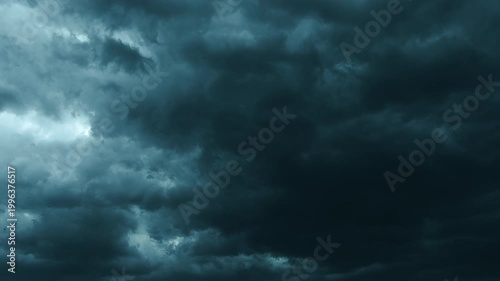 Low Angle Shot of Dark Storm Clouds Moving Fast Towards Camera. Dramatic cinematic footage of heavy dark storm clouds rolling low across the sky