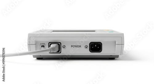 Close-up of a medical device power supply unit with connected cable, highlighting electrical input and control buttons on a white background.