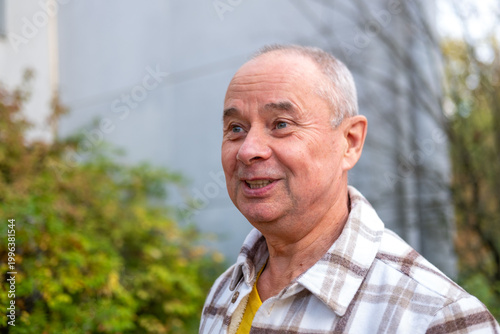 happy positive caucasian mature senior man 60-65 years old smiling on natural background, good mood, age-related changes, mental human health, enjoying nature, golden years