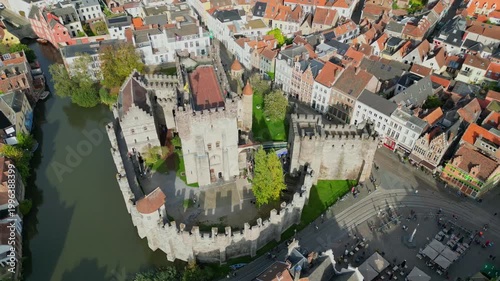 Aerial drone shot of the 10th-century Gravensteen Castle (Castle of the Counts) in Ghent, Belgium. Iconic medieval fortress with its moat and towers in the historic city center.