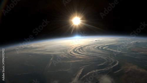 Sunrise over the Earth, seen from space, with the sun's rays piercing through atmospheric clouds, creating a breathtaking view of our planet's horizon.