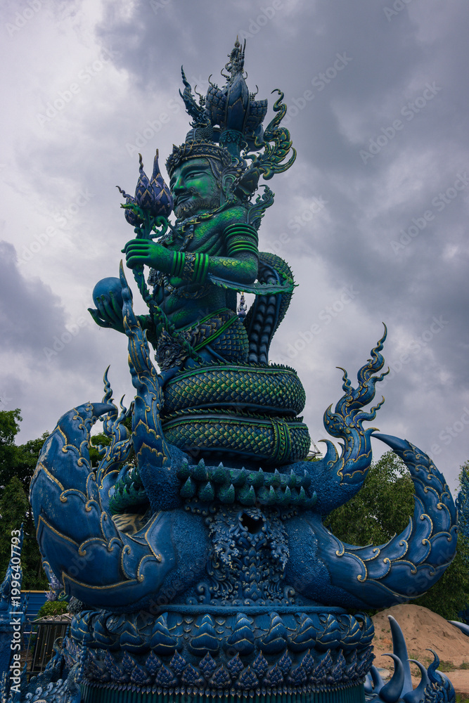 Fototapeta premium Vibrant Blue Temple Wat Rong Suea Ten with ornate gold details in Chiang Rai, Thailand